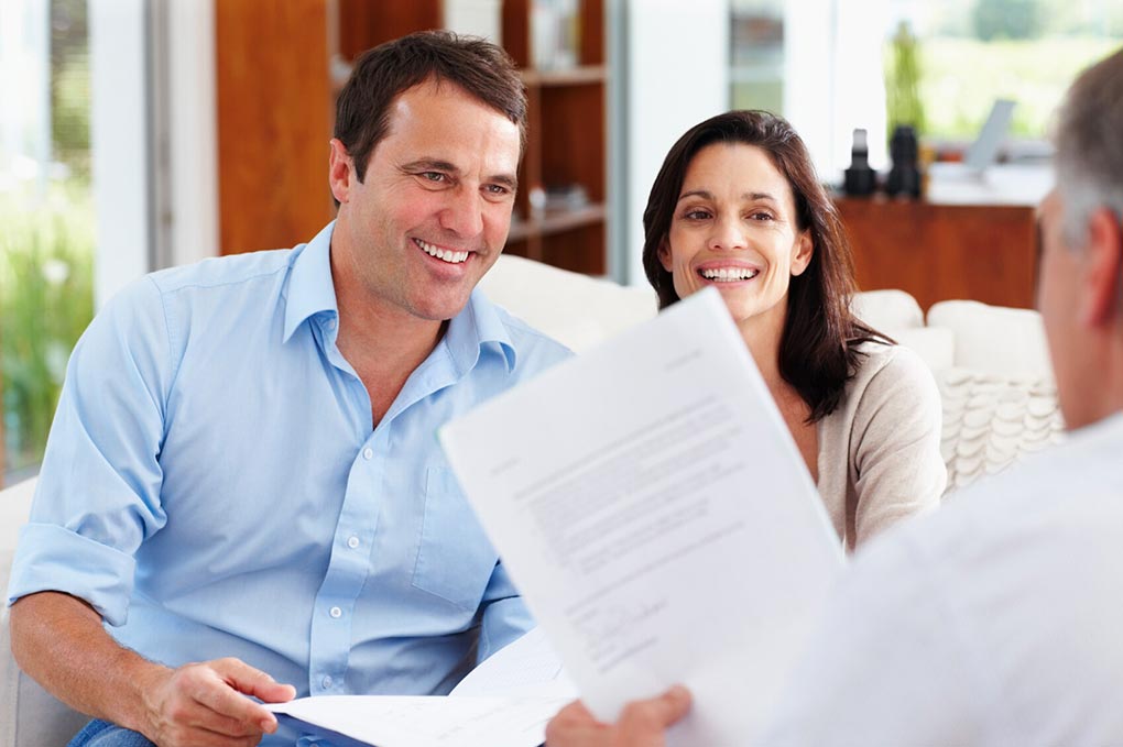 Couple talking with man.